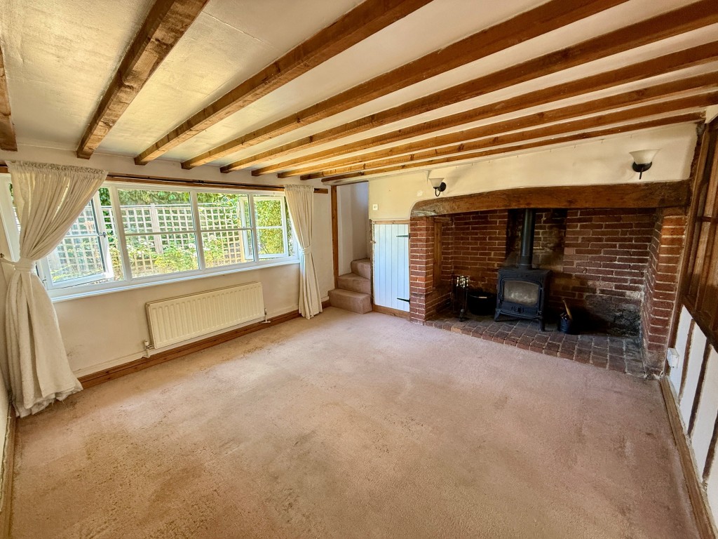 Lot: 224 - DETACHED COTTAGE FOR REFURBISHMENT - Living room with inglenook fireplace